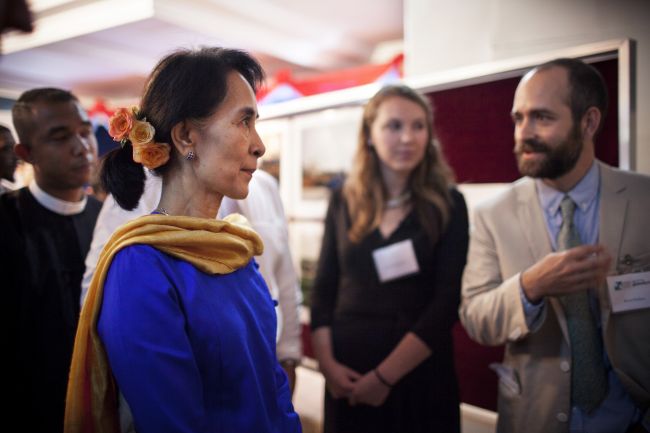 "Myanmar Telling Its Own Story" reporting fellows Kaung Htet, Sarah Fitzpatrick and Bruce Wallace (L-R) with Aung San Suu Kyi (foreground) in Naypyidaw, Myanmar in 2013. (Natalie Keyssar/GroundTruth)